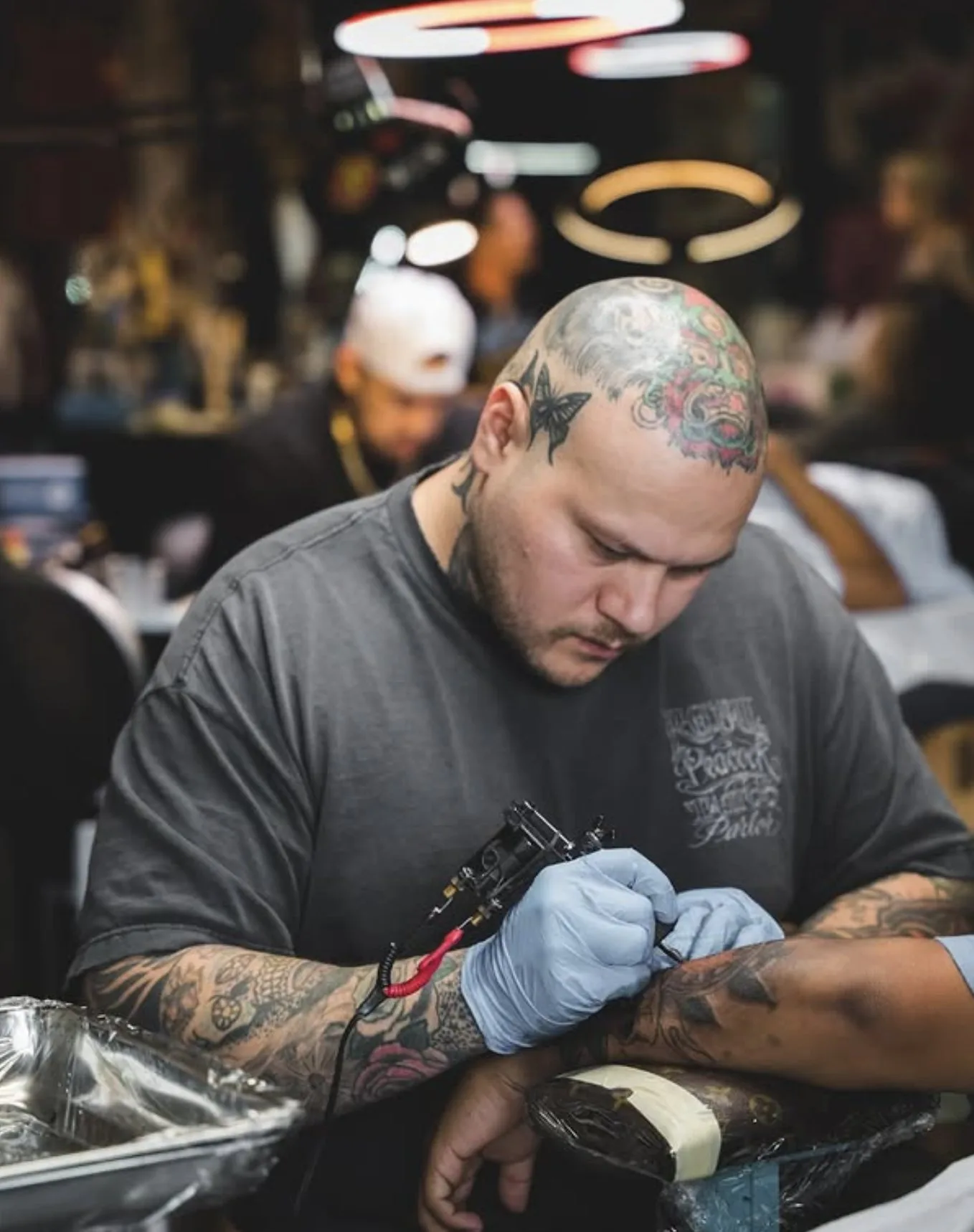 Armando Garza focused on a tattoo session at Eternal Courage Tattoo