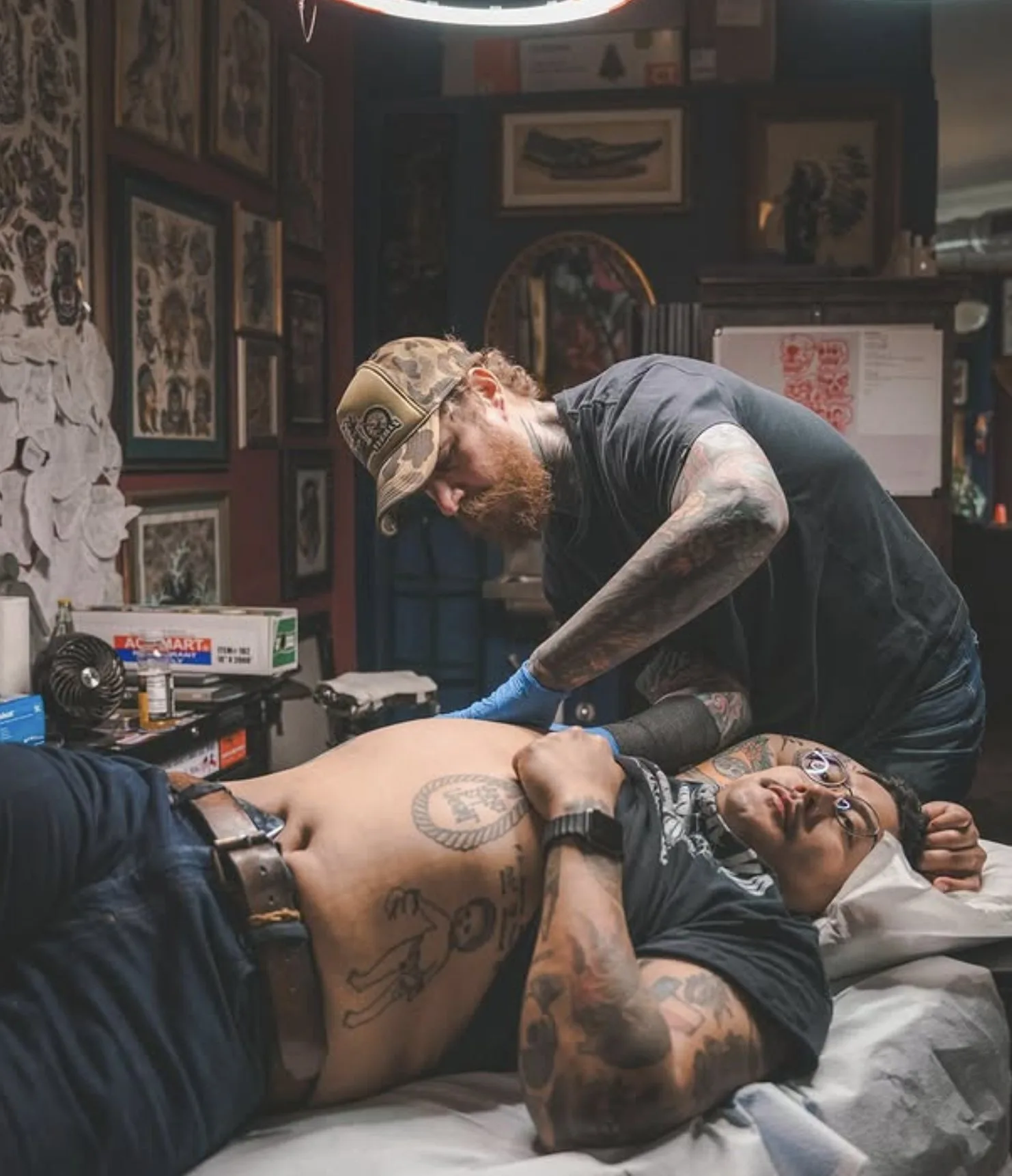 Tyson Wilkinson tattooing a client inside Eternal Courage Tattoo