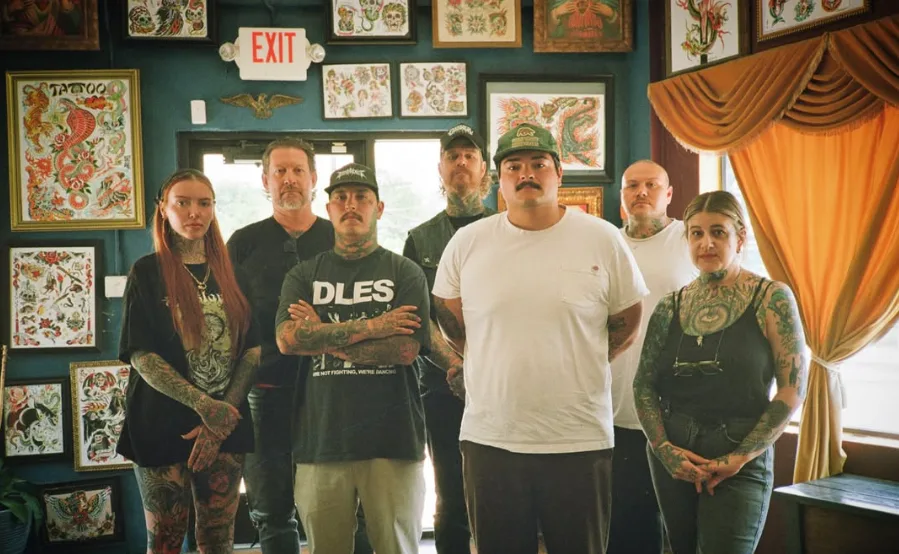 Eternal Courage Tattoo artists standing together inside the San Antonio shop
